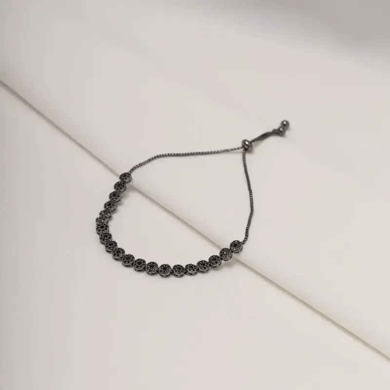 PULSEIRA COM ZIRCÔNIAS NEGRAS FECHO GRAVATINHA BANHO RÓDIO NEGRO